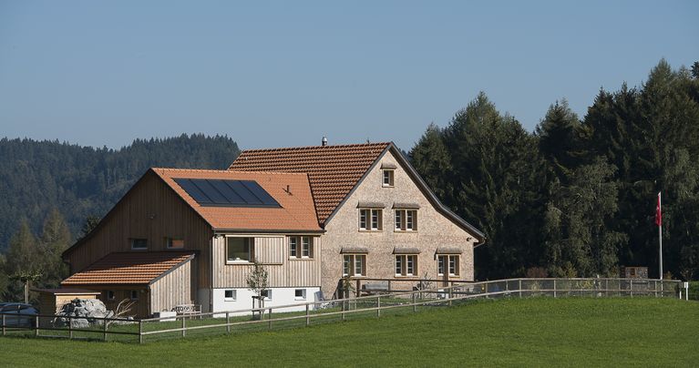 Haus mit Sonnenreflektoren auf dem Dach